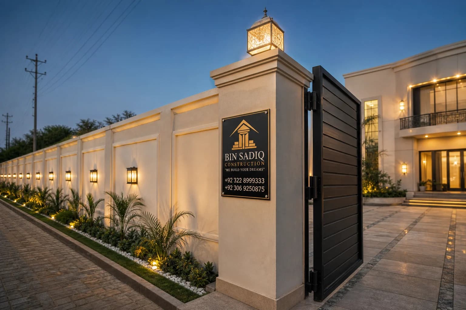 Boundary wall contractor Lahore — dusk wall with pillar lights and Bin Sadiq board