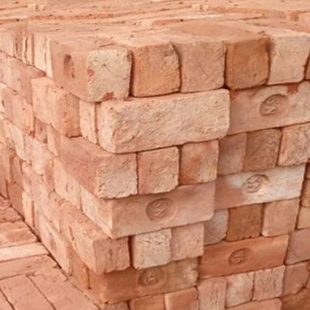 B-Class economy red bricks stack — real yard photo